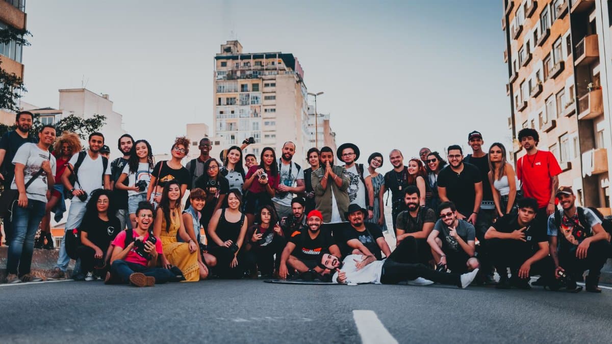 Large diverse group of friends posing happily on a street in São Paulo, Brazil.