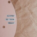 Motivational quote 'Listen to your heart' on a stylish pink and brown textured background.