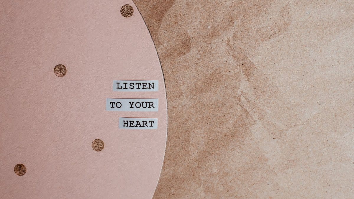 Motivational quote 'Listen to your heart' on a stylish pink and brown textured background.