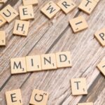Scattered wooden letter tiles on a rustic wood surface highlighting the word 'Mind'. Ideal for mental and cognitive themes.