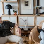 A stressed man and woman therapist in a modern consultation room.