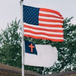 Patriotic display of American and Christian flags on rooftop in Springfield, IL.