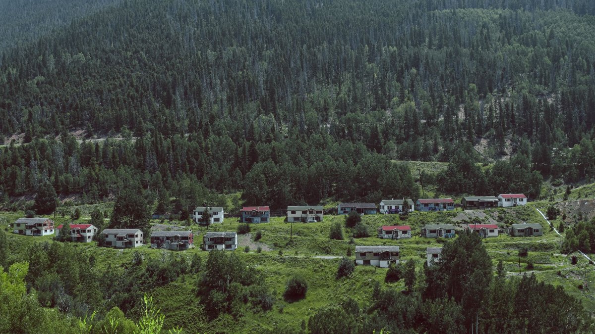 Explore the remains of an abandoned mining town nestled in a lush Colorado mountain valley.