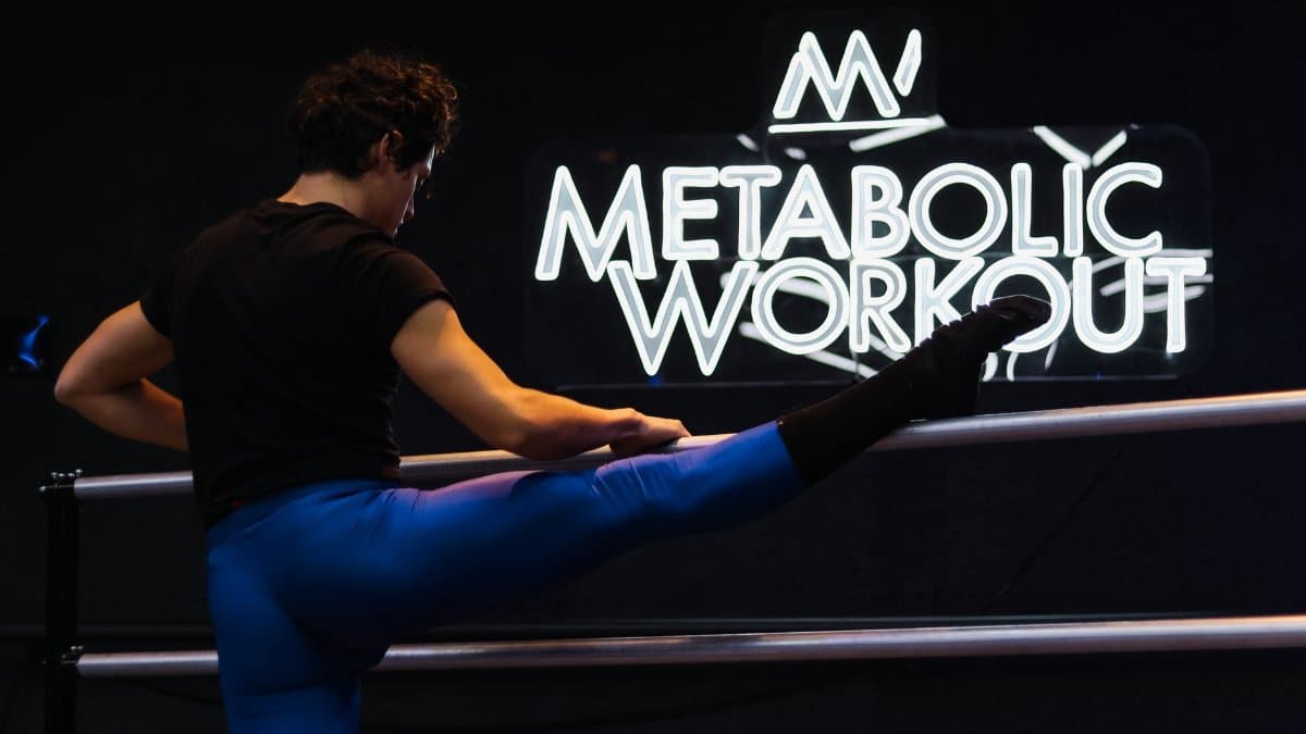 Athlete performing a leg stretch at Metabolic Workout studio in Mexico City.