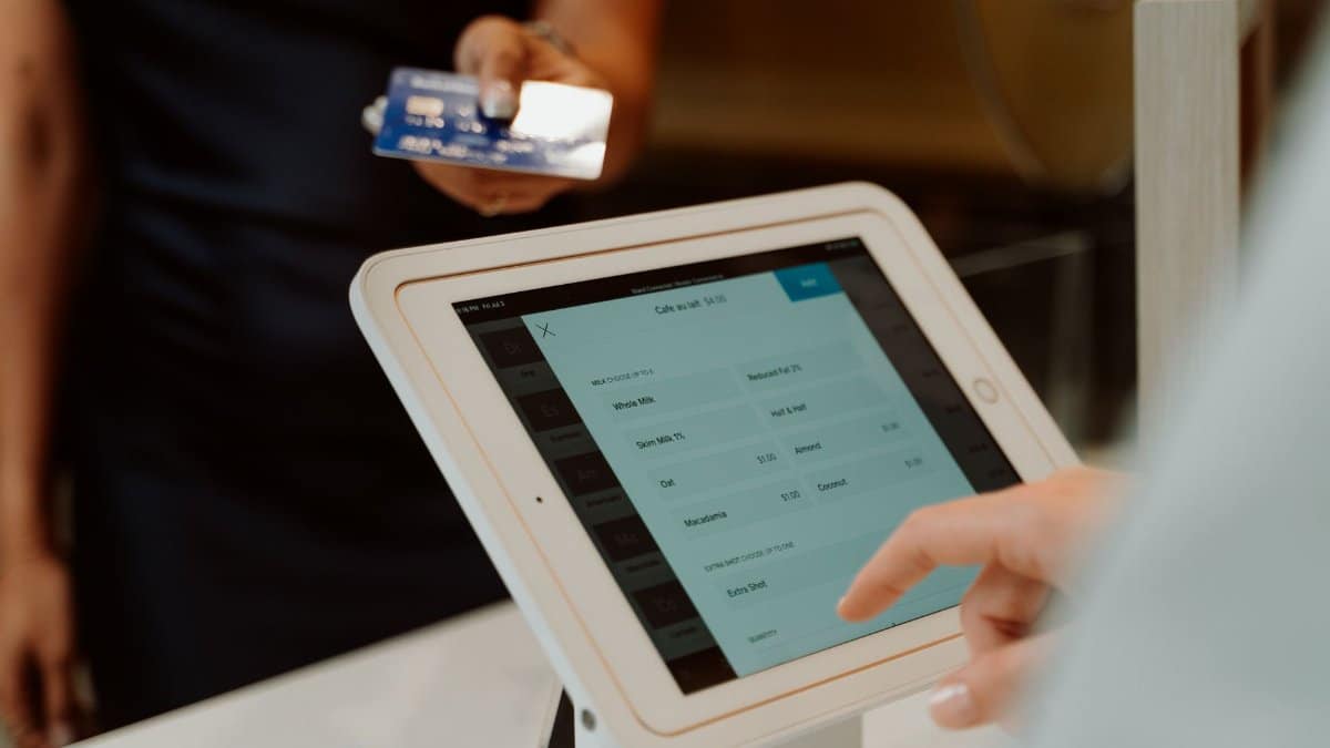 A modern cashless payment system using a tablet and card for seamless transactions.