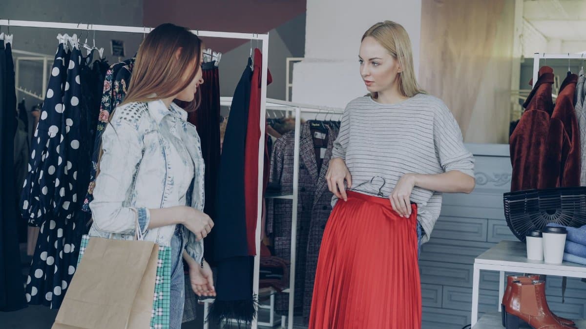 Two women shopping for clothes in a stylish boutique.