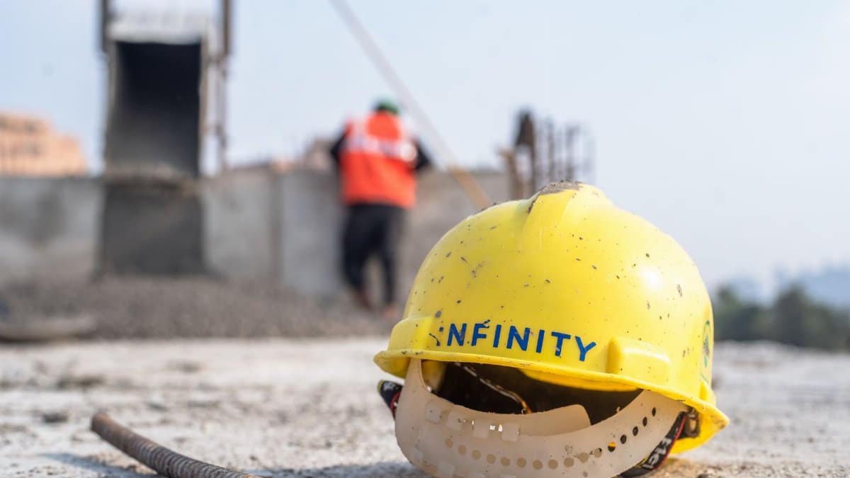 Close-up of a yellow safety helmet on a construction site in Delhi.