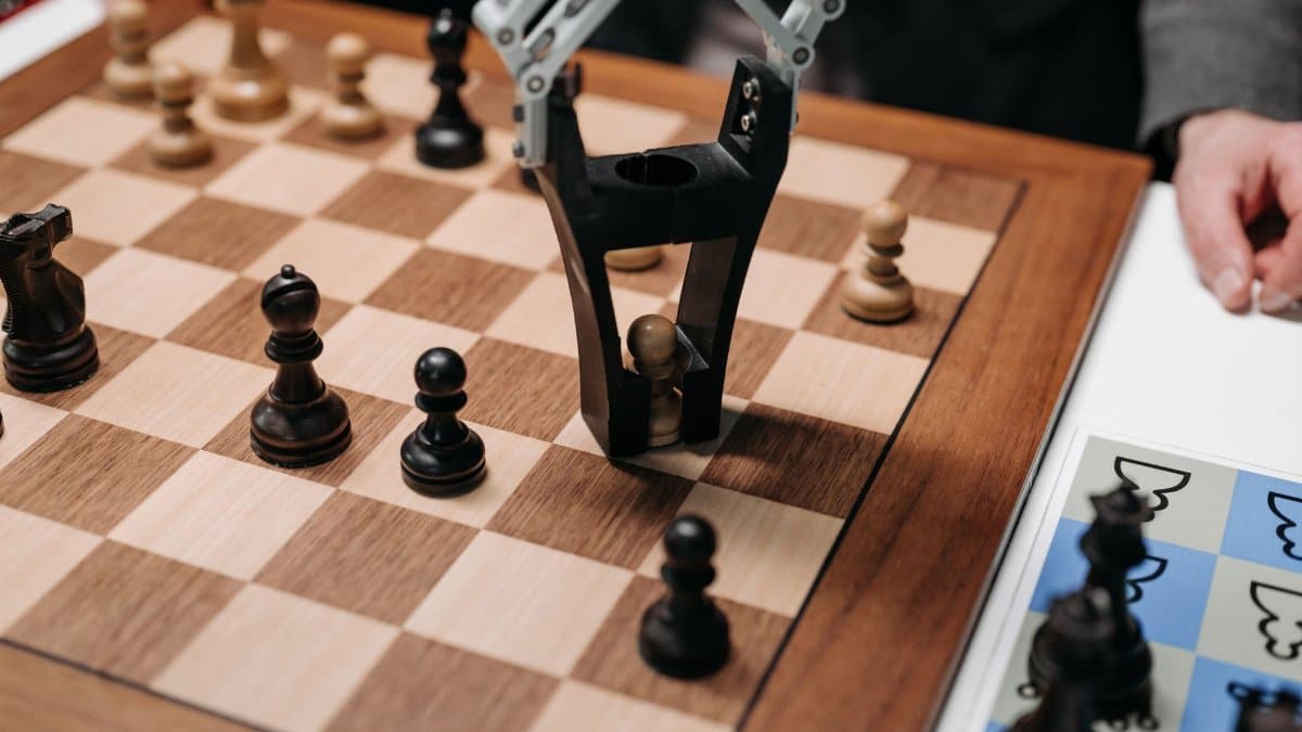 Robotic arm playing a strategic chess game on a wooden board, showcasing technology and innovation.