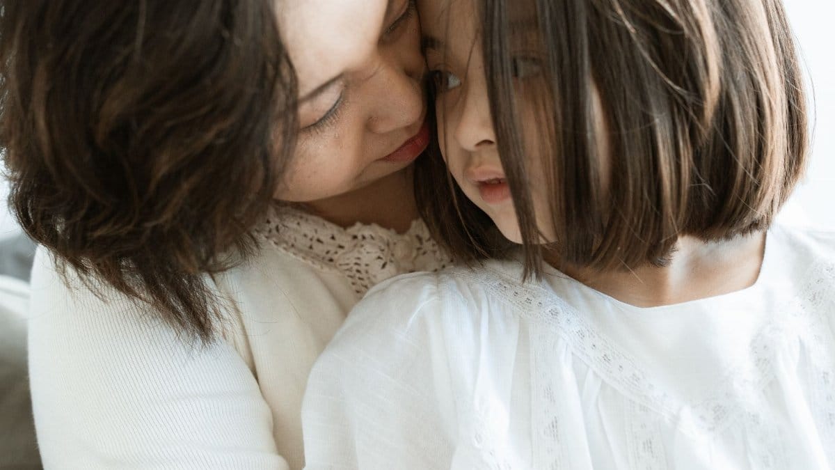 Tender moment between mother and daughter, highlighting love and connection.