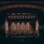Orchestra performing a symphony in a grand theater, showcasing exquisite classical music.
