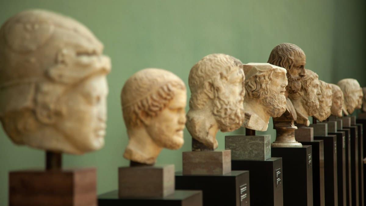 Ancient sculptures displayed in a museum setting, showcasing historical art.