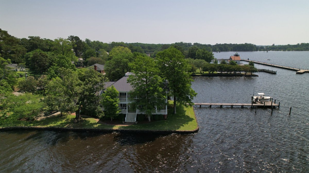 Stunning aerial shot of a serene waterfront property and dock in North Carolina.
