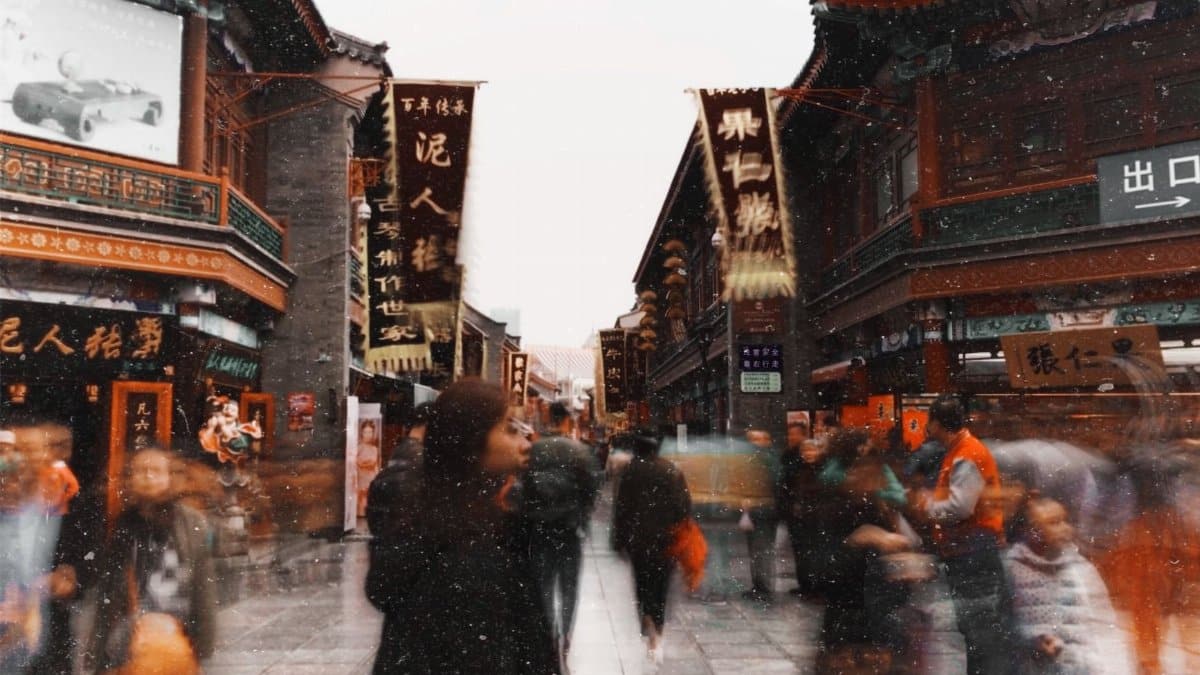 Dynamic street scene with blurred motion, showcasing traditional Asian architecture and signage.