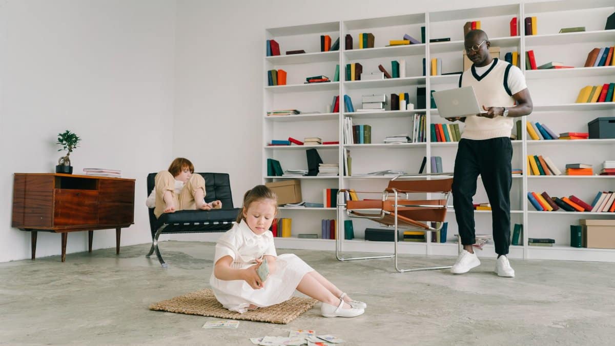 Child playing while adults work in a contemporary office library space.