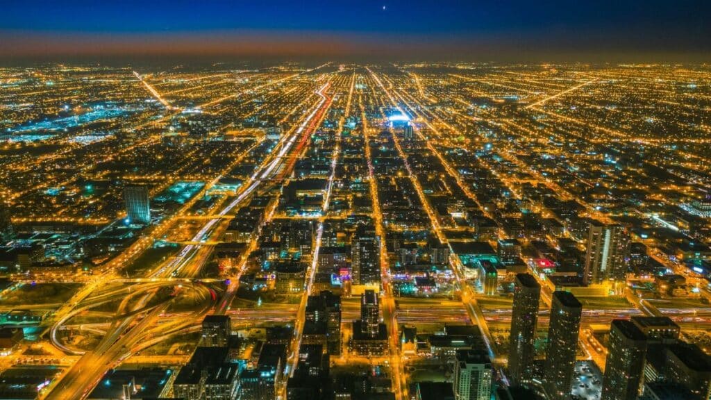 A stunning aerial shot showcasing the vibrant city lights of Chicago at twilight.