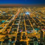 A stunning aerial shot showcasing the vibrant city lights of Chicago at twilight.