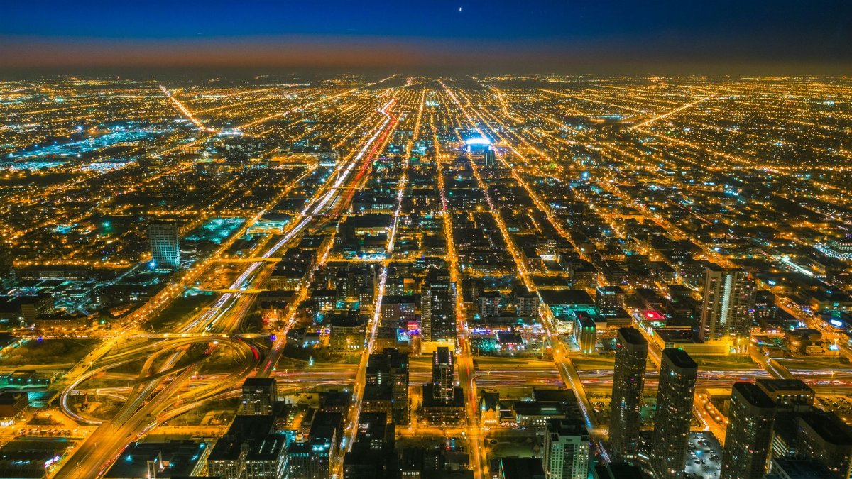 A stunning aerial shot showcasing the vibrant city lights of Chicago at twilight.