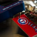 Detailed close-up of a Texas Rangers keychain featuring vibrant colors and logo.