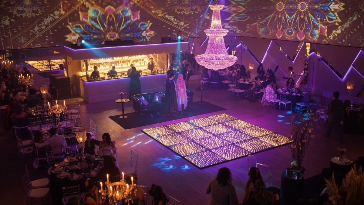 Elegant indoor party with vibrant lighting and luxurious decor, capturing a festive atmosphere.