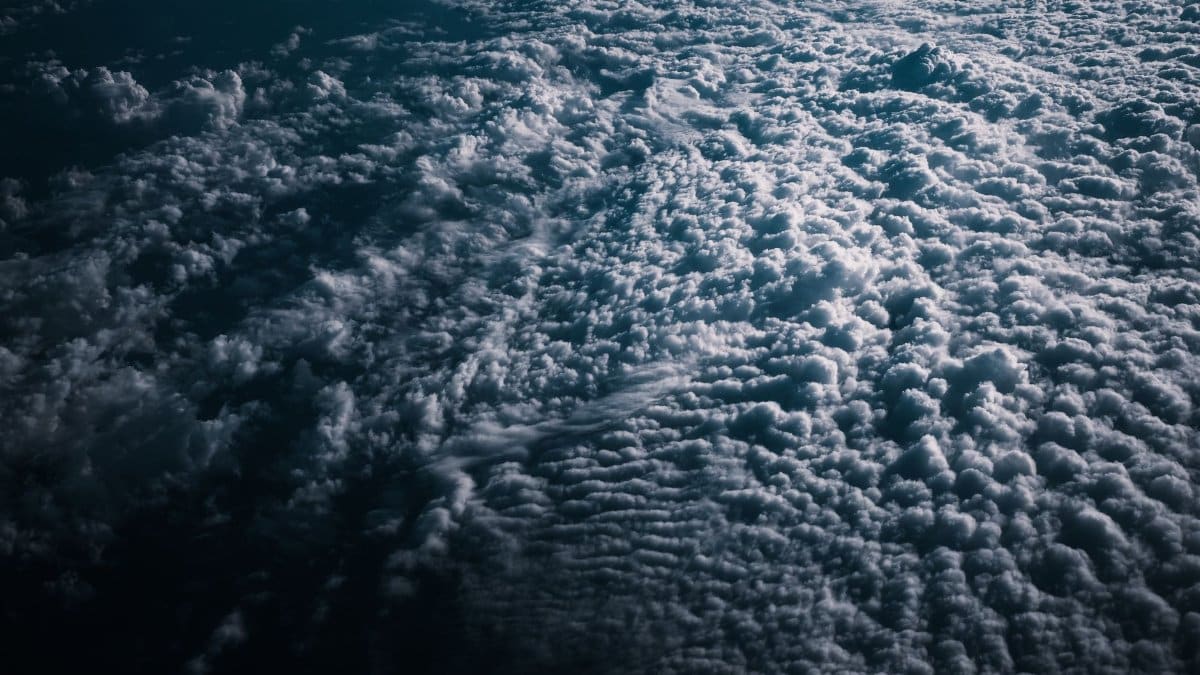 Stunning aerial image capturing a dramatic cloudscape at twilight, perfect for atmospheric backgrounds.