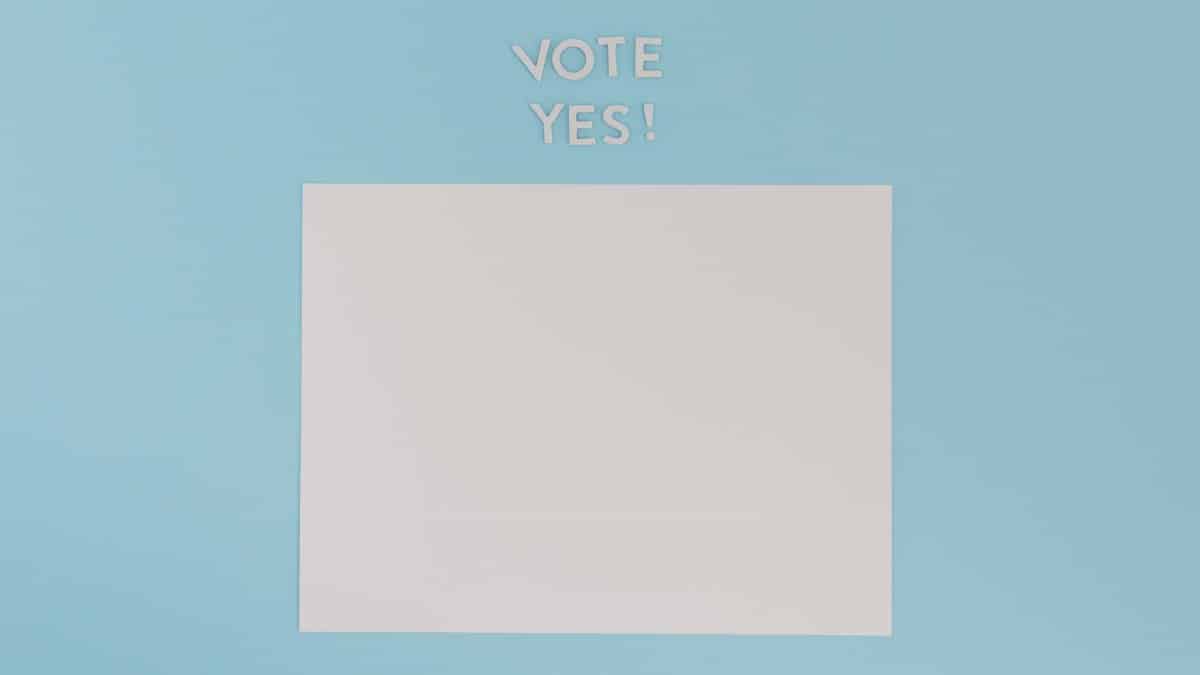 A blank sheet of paper with 'Vote Yes!' text on a blue background, ideal for conceptual designs.