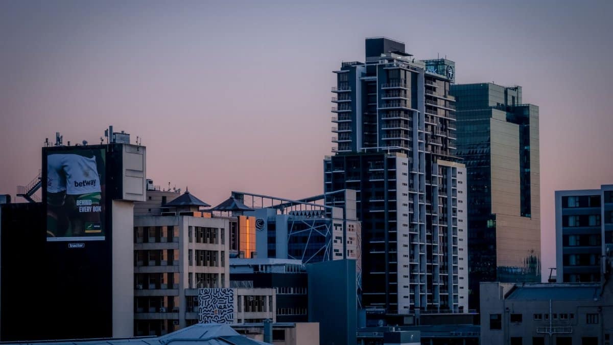 Modern buildings under a pastel sky in Cape Town, South Africa at sunset.