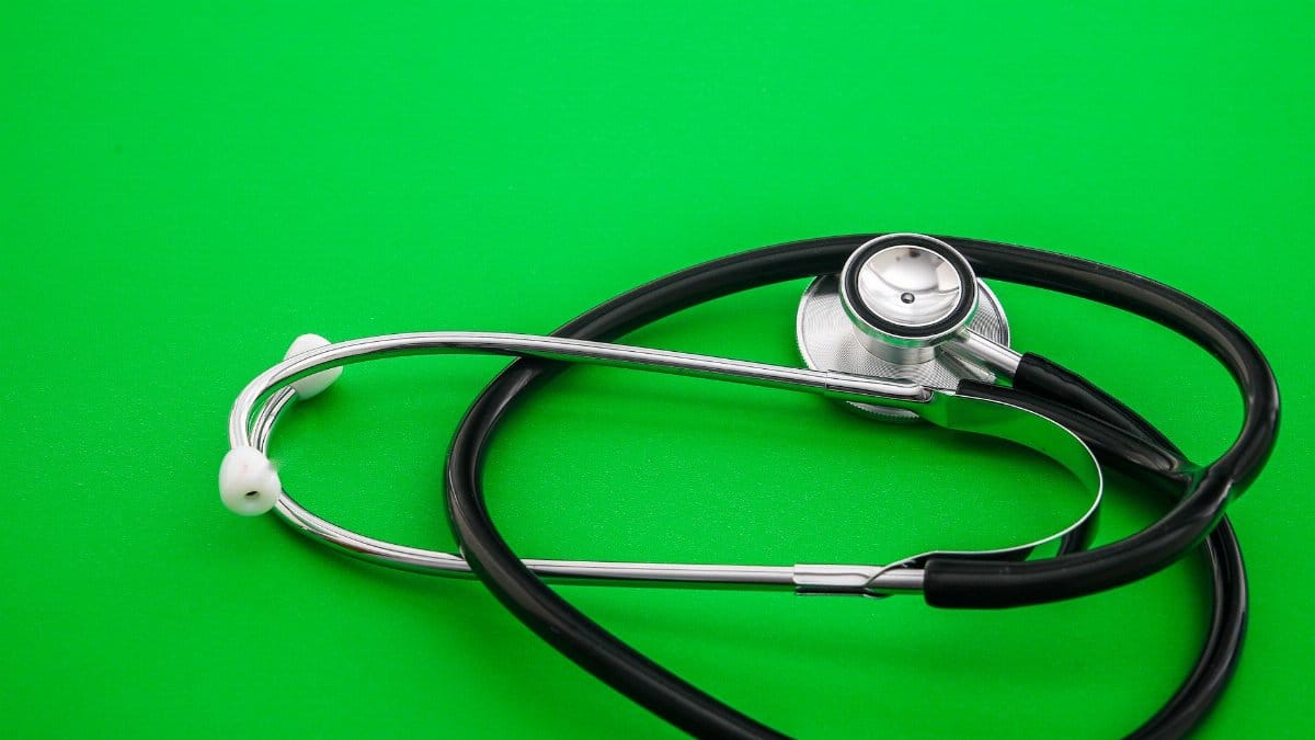 Stethoscope placed on a vibrant green background, symbolizing healthcare and medical practice.