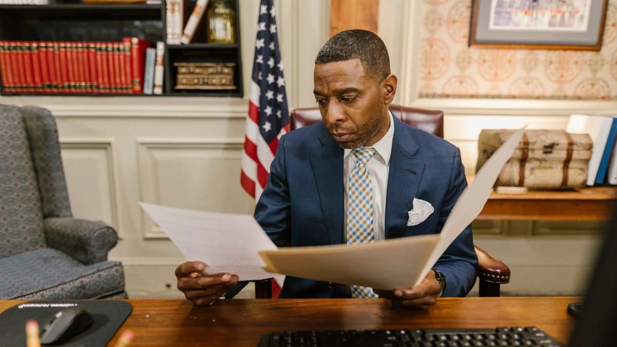 A lawyer reading documents in an office setting, conveying professionalism and focus.