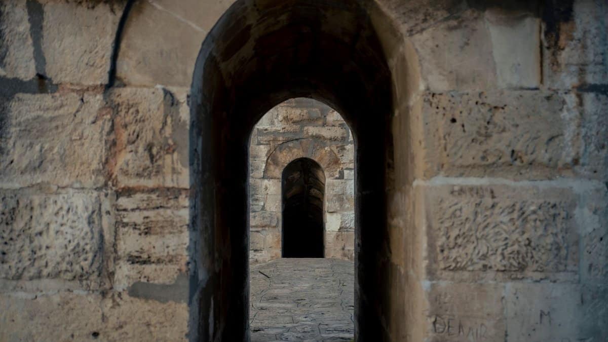 Stone passage with arched design, showcasing historic architectural elements.