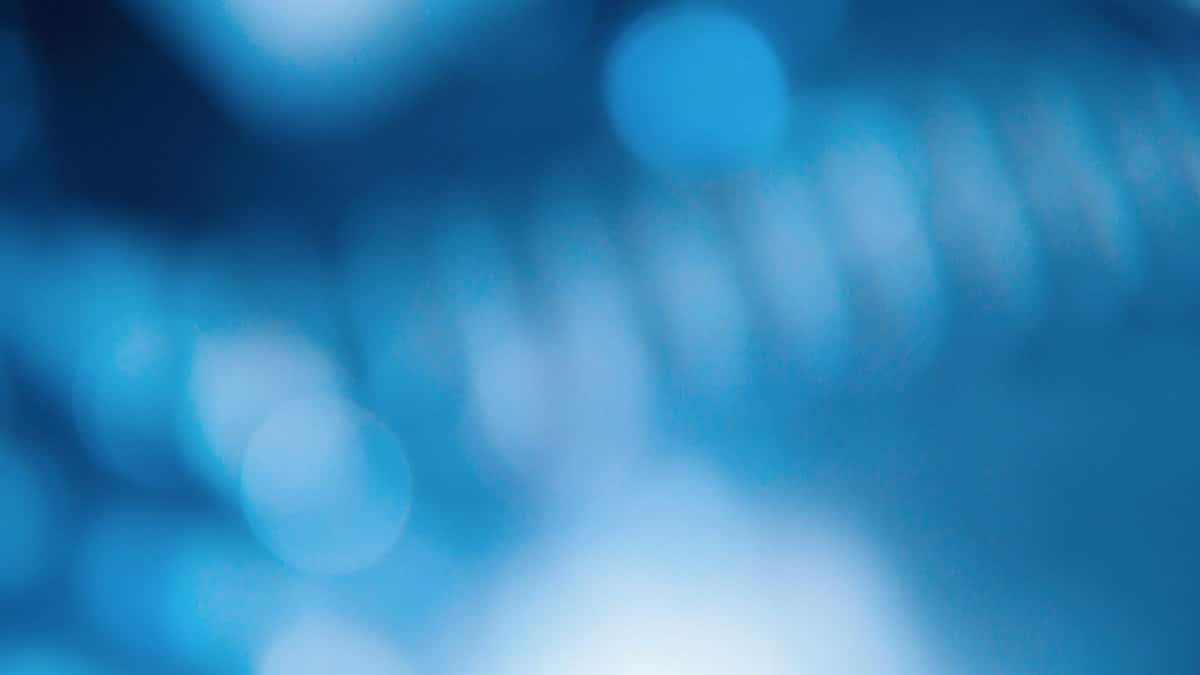 Blurred abstract blue bokeh background with a dreamy soft focus effect.