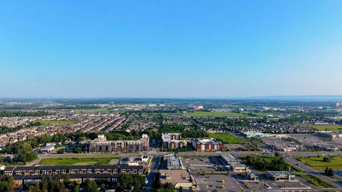 Aerial image showcasing a suburban neighborhood under a clear blue sky.
