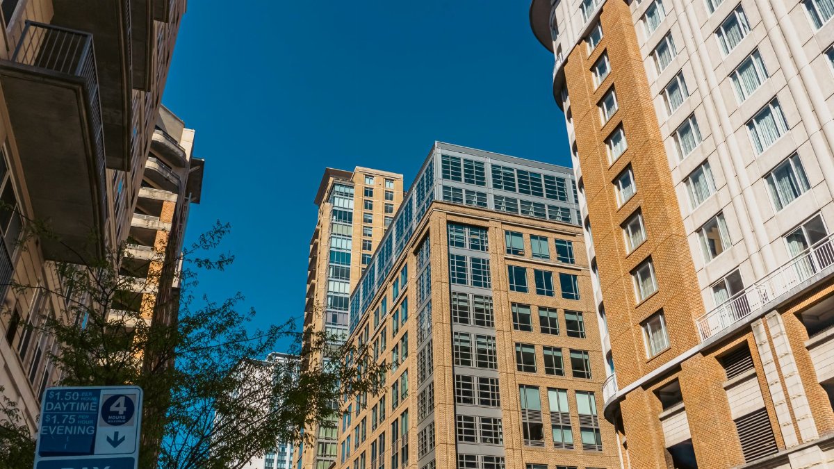 High-rise buildings in Baltimore against a clear blue sky with urban vibes.