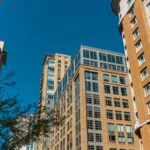 High-rise buildings in Baltimore against a clear blue sky with urban vibes.