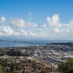 Aerial view of the Bay Area landscape with a vibrant sky and harbor.
