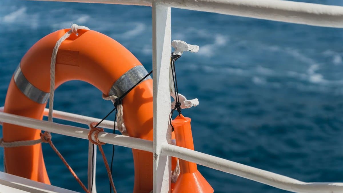 Close-up of a lifebuoy on a ship's railing against the blue ocean in Croatia.