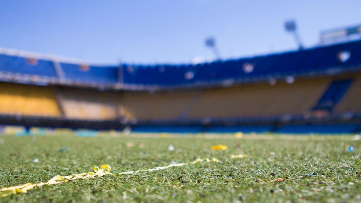 Close-up view of a vibrant football pitch in a sunlit Buenos Aires stadium, perfect for sports enthusiasts.