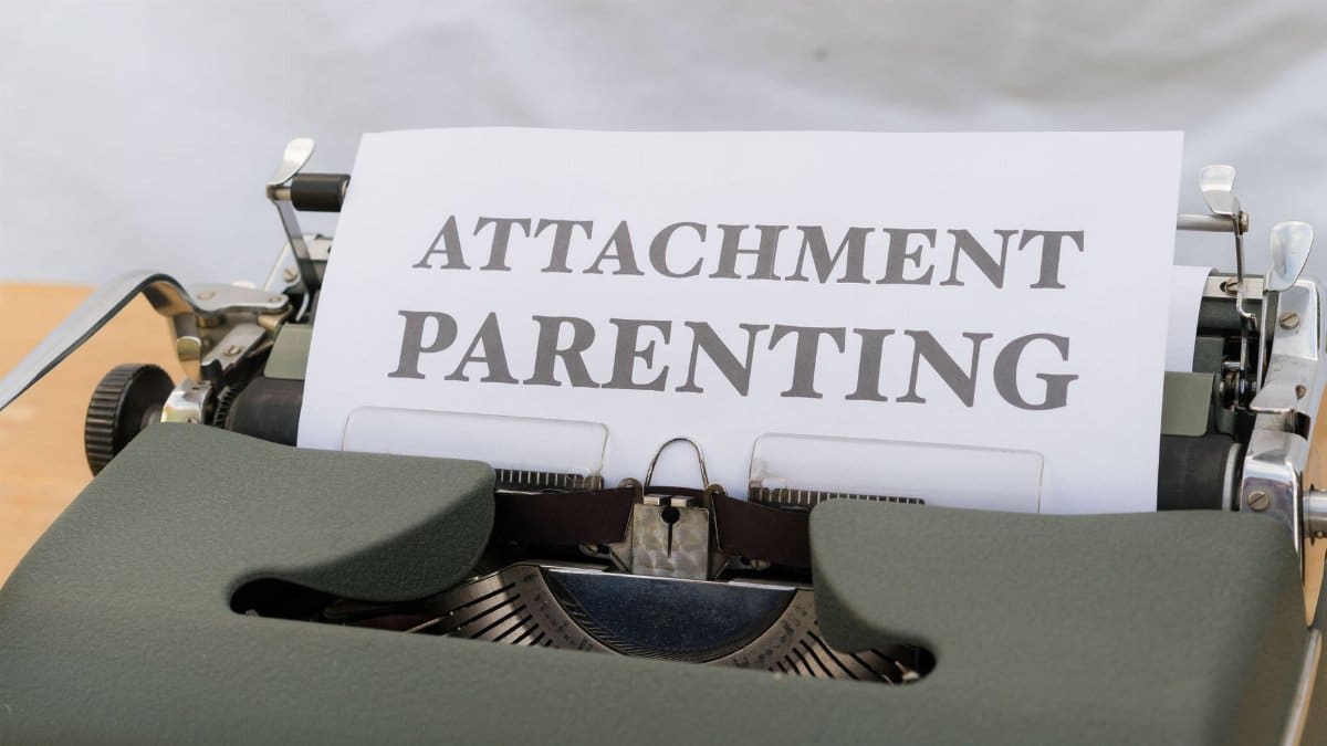 Close-up of a vintage typewriter with 'ATTACHMENT PARENTING' paper sheet.