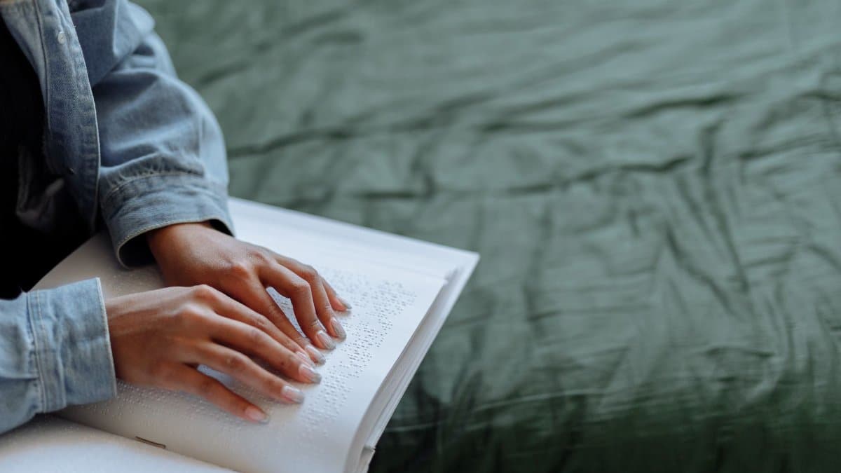 A person reading Braille text, focusing on touch and sensory perception.