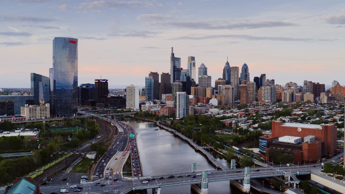 Stunning aerial view of Philadelphia's skyline with iconic skyscrapers and the Schuylkill River during the day.
