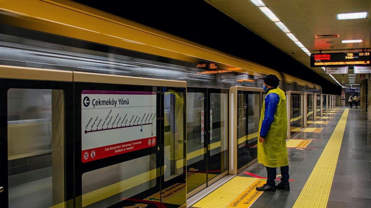 A man in protective gear waits on an Istanbul subway platform. Metro station scene in Istanbul, Turkey.