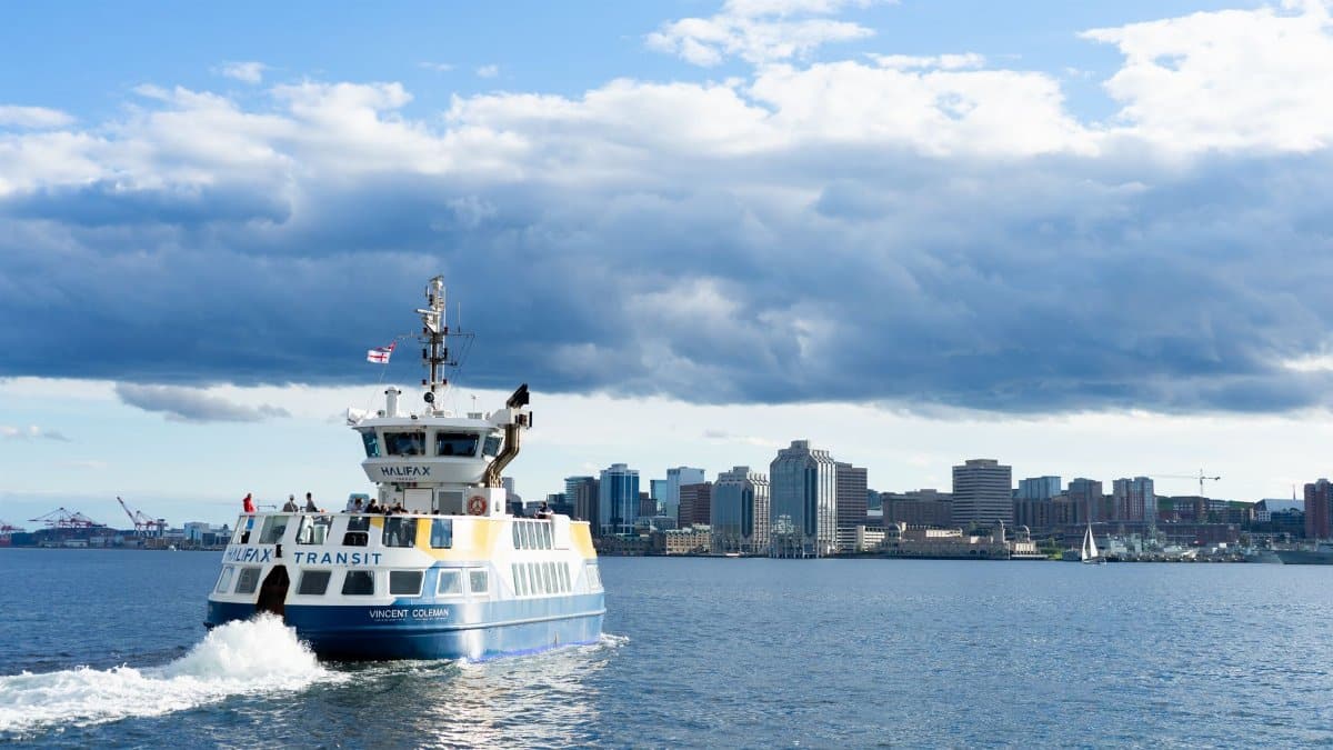 Halifax Transit ferry crossing the harbour with the downtown skyline in the background on a clear day.