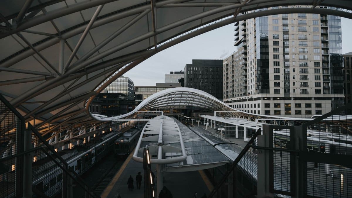 View of the sleek contemporary design at Denver Union Station with downtown buildings.