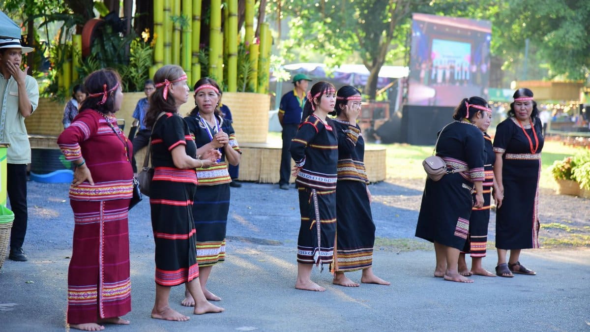 A group of women in traditional attire at an outdoor cultural event.