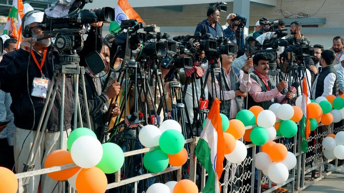 Journalists and videographers gather with cameras in Ahmedabad, capturing a vibrant scene.