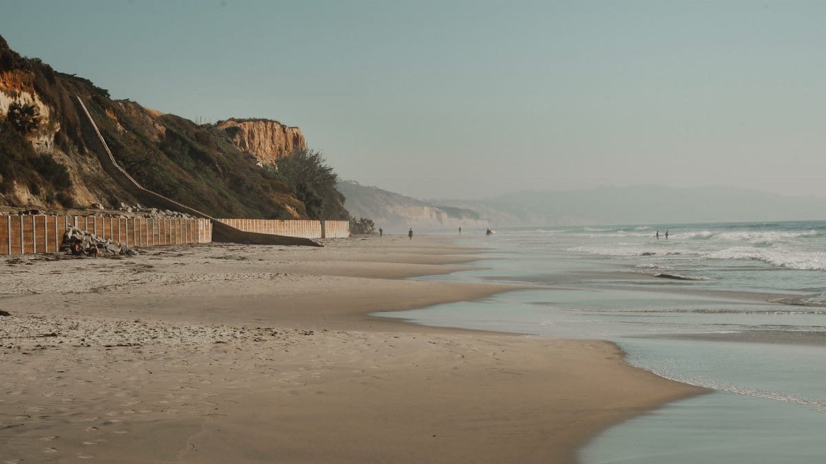 Peaceful California beach scene with stunning cliffs and tranquil ocean waves.