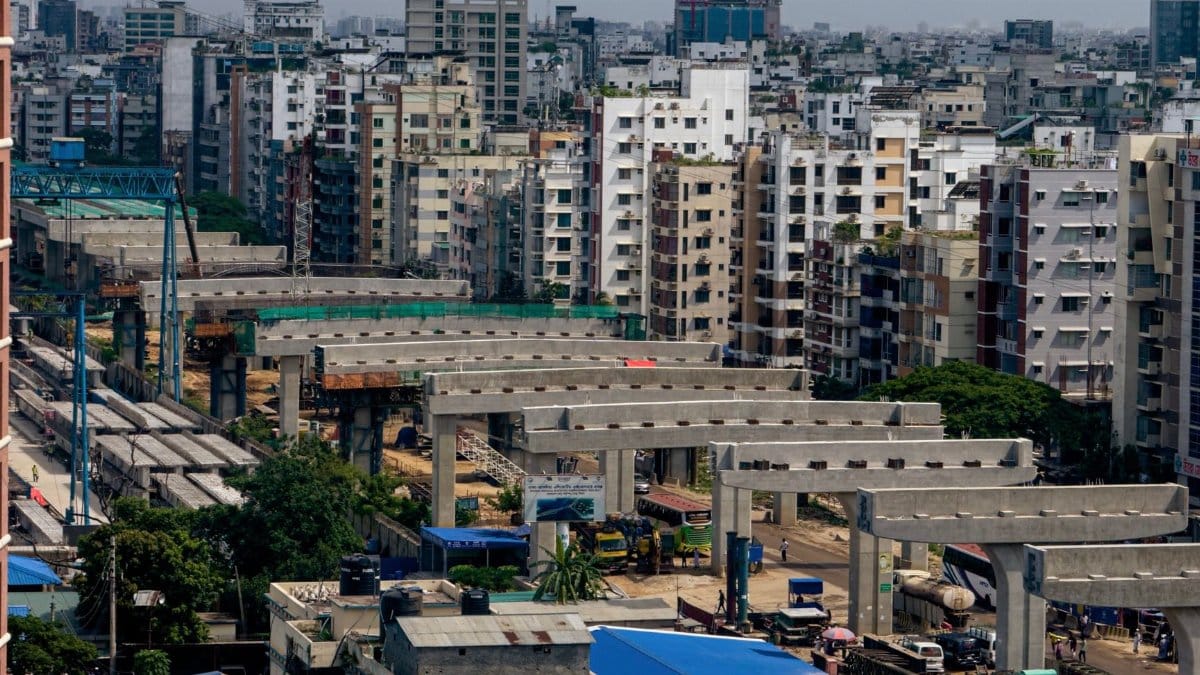 Aerial view of urban construction amidst tall buildings in a bustling cityscape.