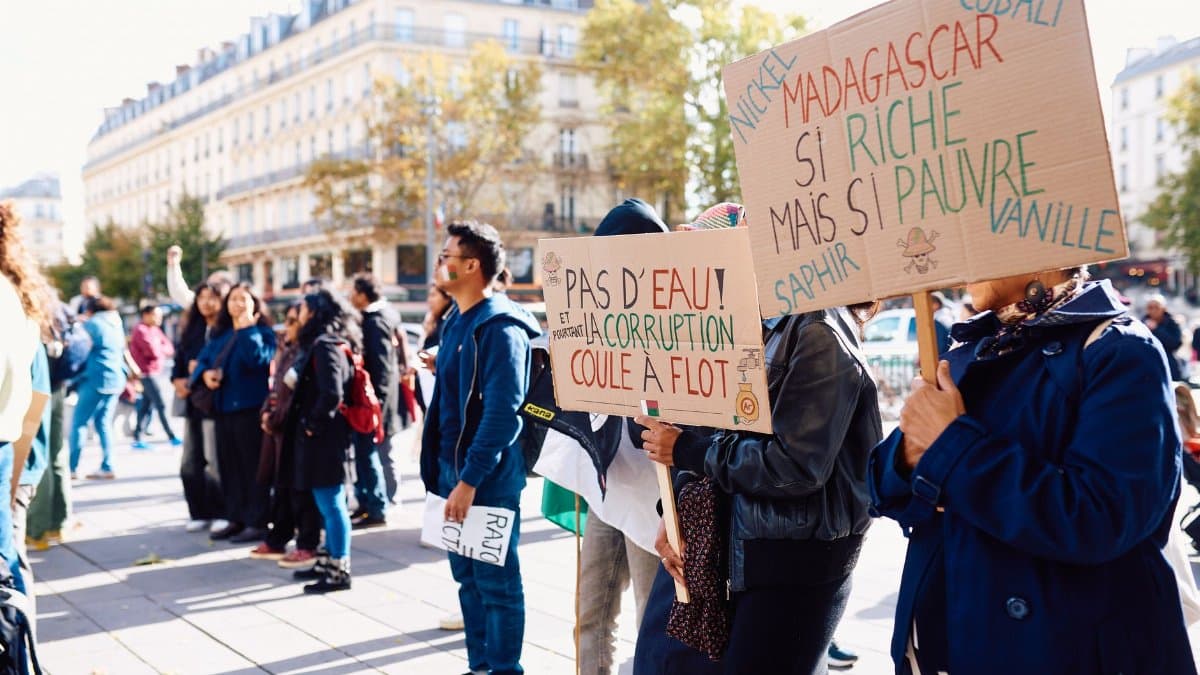 Crowd gathering for a peaceful protest in Paris, raising awareness about Madagascar's political issues.