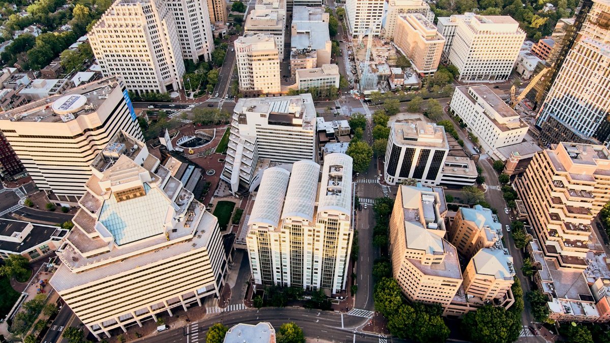 Aerial view of new residential district with contemporary buildings and well developed infrastructure at sunset