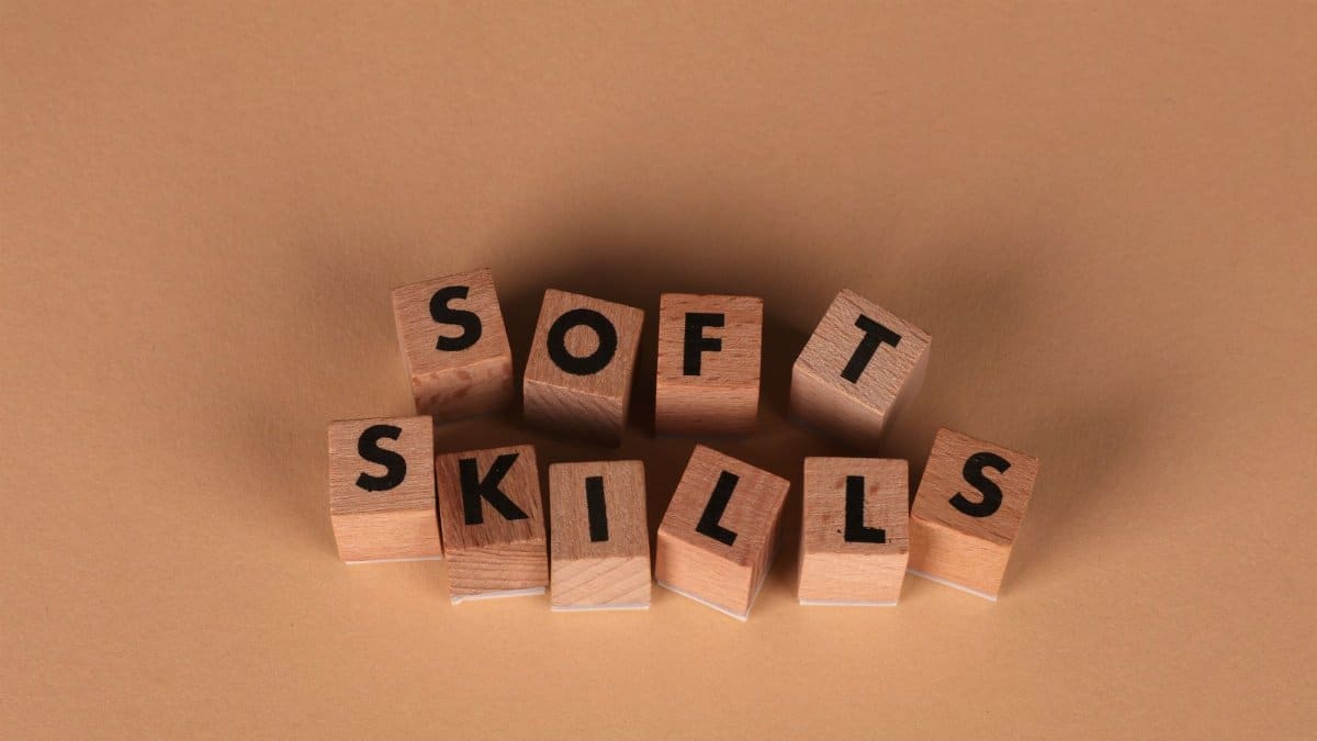 Wooden letter blocks spell out 'Soft Skills', highlighting business and personal development concepts.