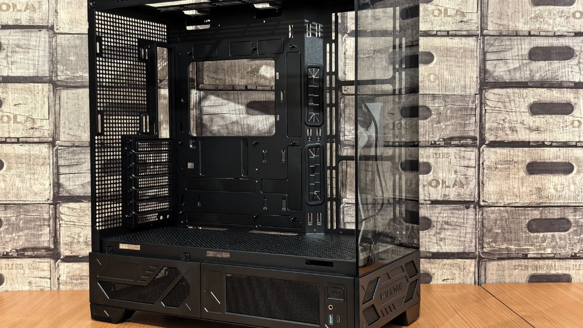 Modern black PC gaming tower case with tempered glass panels on wood table, ideal for custom builds.